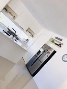 a kitchen with a stove, sink and cabinets at White Shells Luxury Apartments in Marcoola