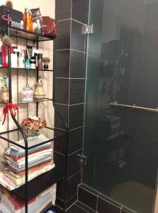 a shower with a glass door and some books at ANCA apartment in Paleo Tsifliki