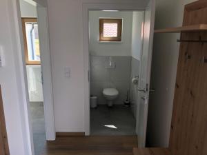 a bathroom with a toilet and a window at Gusto Lodges in Klöch