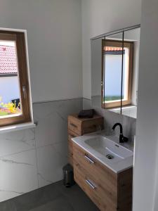 a bathroom with a sink and two windows at Gusto Lodges in Klöch