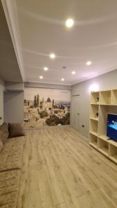 a large living room with a couch and a television at Home Boutique Hostel in Baku