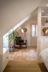 a bedroom with a staircase with a couch and a plant at Modern and Stylish WoodHous in Forfar