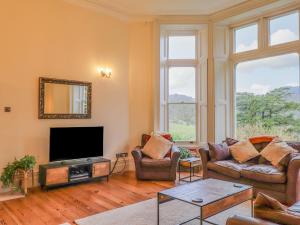 a living room with two couches and a flat screen tv at Rydal Suite in Ambleside