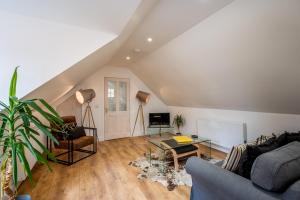 a living room with a couch and a table at Modern and Stylish WoodHous in Forfar