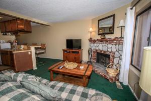 a living room with a couch and a fireplace at Boulder Creek -1417 by Big Bear Vacations in Big Bear Lake