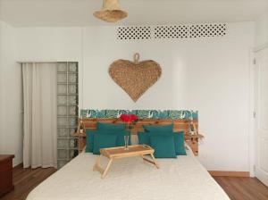 a bedroom with a bed with a heart on the wall at Beautiful beach in Santa Cruz de Tenerife