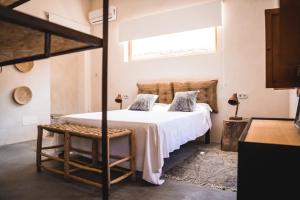 a bedroom with a large bed and a window at Son Mesquida Vell in Manacor