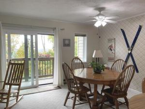 a dining room with a wooden table and chairs at APPresSki - 5 bed Ski in Ski out - 50 Steps to Ski Sugar Mountain Slopes in Sugar Mountain