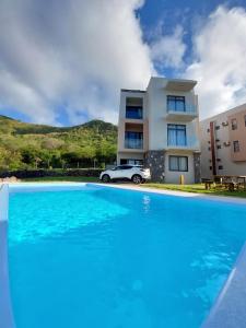 a villa with a swimming pool in front of a house at Laolabaone in La Gaulette