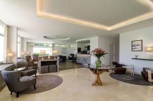 a living room with a table and some chairs at Hotel du Parc in Arcachon