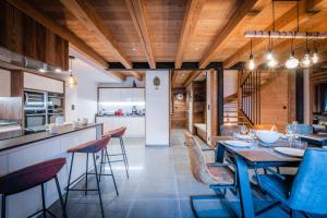 a kitchen and dining room with a table and chairs at Chalet Izoard in Saint-Chaffrey