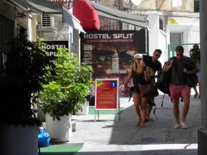 a group of people walking down a street at Hostel Split in Split