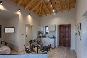 a kitchen and living room with a table and chairs at Althea Apartments 1 in Halki