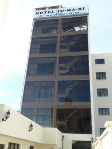 a building with a sign on the top of it at Hotel Jumari in Uyuni