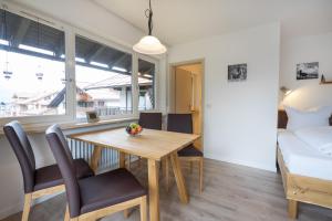 comedor con mesa, sillas y cama en Ferienwohnung Bakker en Oberstdorf