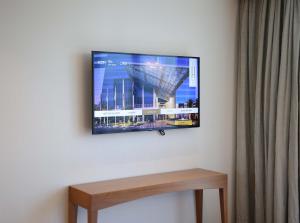 a flat screen tv hanging on a wall at The H Dubai in Dubai