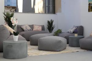 a living room with grey couches and a rug at Moontels Paseo de Ruzafa in Valencia