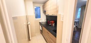 a small kitchen with a black counter top at Boel 4 Studio in Geneva