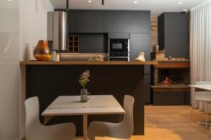 a kitchen with a table and a table and chairs at Civitaloft Luxury Rooms in Civitanova Marche