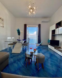 a living room with a table and a dining room at IL PROFUMO DEI FIORI SUITE in Praiano