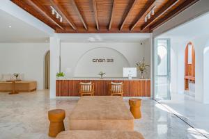 a lobby with a table and chairs and a counter at Casa 33 Hatyai in Hat Yai +35 photos