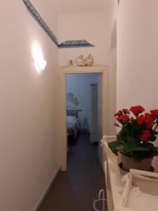 un pasillo con una habitación con una cama y flores en L'Angelo Blu, en La Spezia
