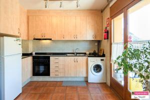 a kitchen with a washer and a sink and a dishwasher at Apartament Tritó - Rústico y acogedor con vistas - 2p in Guardiola de Berguedà