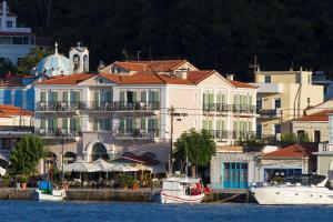 a group of buildings with boats in the water at Samaina Port Hotel in Karlovasi