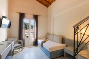 a bedroom with a bed and a chair and a window at Samaina Port Hotel in Karlovasi