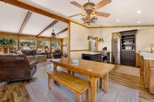 a kitchen and living room with a wooden table at Happy Bear #2053 by Big Bear Vacations in Big Bear Lake