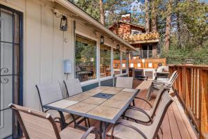 a wooden table and chairs on a deck at Happy Bear #2053 by Big Bear Vacations in Big Bear Lake