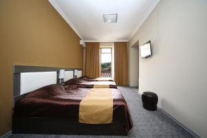 Voodi või voodid majutusasutuse Discovery Hotel toas