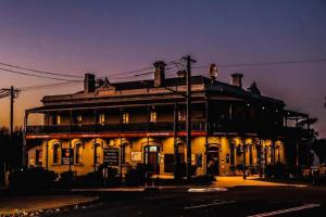 an old building is lit up at night at Oriental Hotel Tumut in Tumut