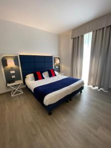 Letto o letti in una camera di Hotel Rombino