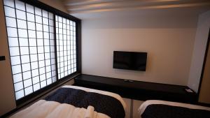 Voodi või voodid majutusasutuse LC Goryokaku Hotel toas