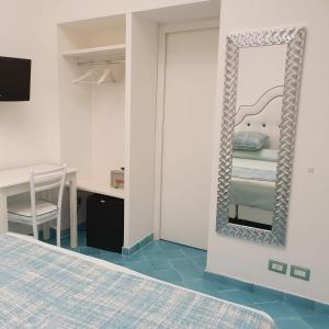 
a bedroom with a bed and a dresser at Albergo S. Andrea in Amalfi
