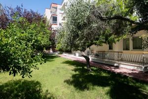 a yard in front of a house with a tree at Otium Boutique Happy Suites in Antalya