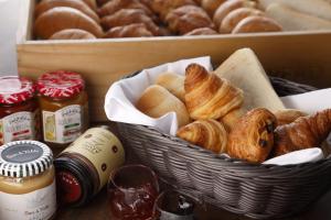 a basket of bread and pastries sitting on a table at Sapporo Tokyu REI Hotel in Sapporo