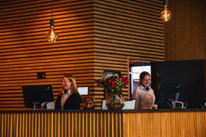 a man and a woman sitting at a counter at Sorrisniva Arctic Wilderness Lodge in Alta