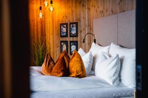 a bed with four brown shoes on it at Sorrisniva Arctic Wilderness Lodge in Alta