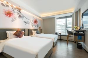 Letto o letti in una camera di Paco Hotel Canton Tower Pazhou