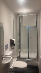 a bathroom with a shower and a toilet and a sink at Park View in Hull