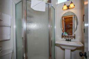 a bathroom with a shower and a sink and a mirror at Palms To Pines-1877 by Big Bear Vacations in Sugarloaf +17 photos