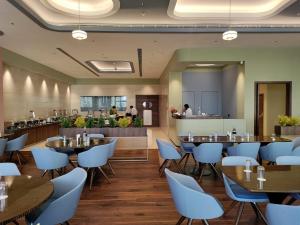 a restaurant with tables and chairs and a bar at Damson Plum in Lucknow
