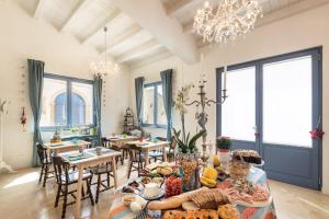 a living room with a table with food on it at MichaEl garden in Noto