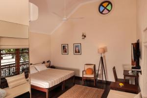 a bedroom with two beds and a clock on the wall at Samiira on Ashtamudi Lake in Kollam