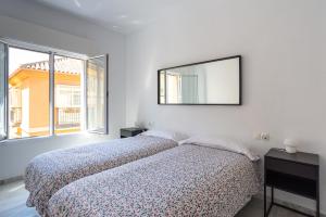 A bed or beds in a room at LU&CIA THYSSEN CITY CENTER