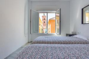 A bed or beds in a room at LU&CIA THYSSEN CITY CENTER