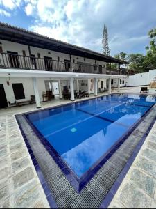 a large swimming pool in front of a building at Ahangama Eco Villa in Ahangama