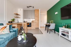 a living room with a couch and a table at Magic Place - Francuska Park - Free Garage - Self Check-in in Katowice